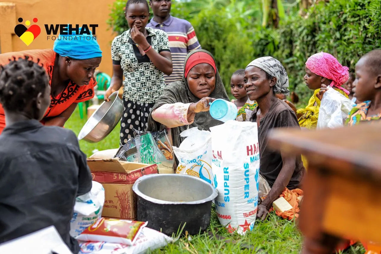 Mothers after recieving household items from WEHAT Foundation Uganda NGO during christmas outreach 2023